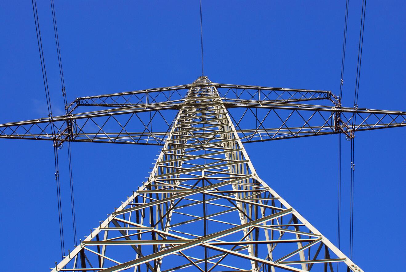 Strommast von unten in Richtung blauer Himmel fotografiert